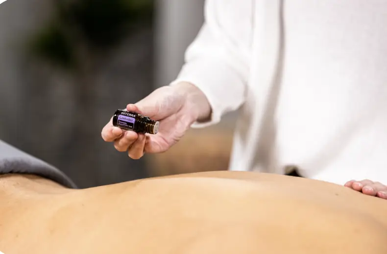 Therapeutic massage with essential oils in calming treatment room
